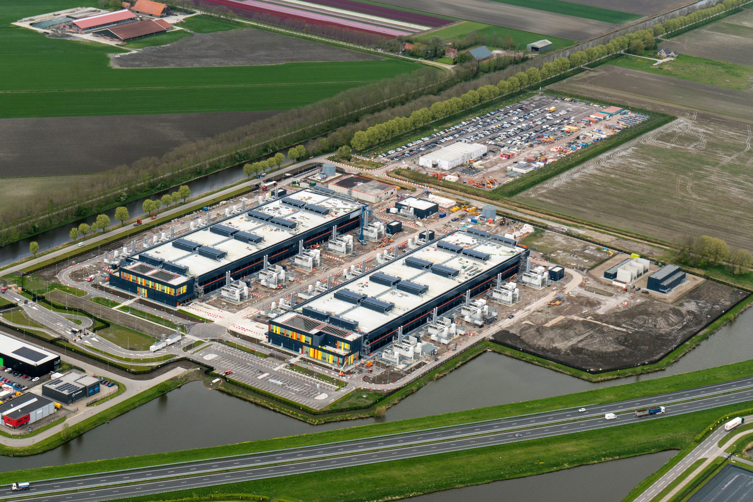 Aerial view of construction site for a Microsoft data center in Middenmeer, Netherlands. The huge building is located between greenhouses and agricultural environment. Photo: Shutterstock